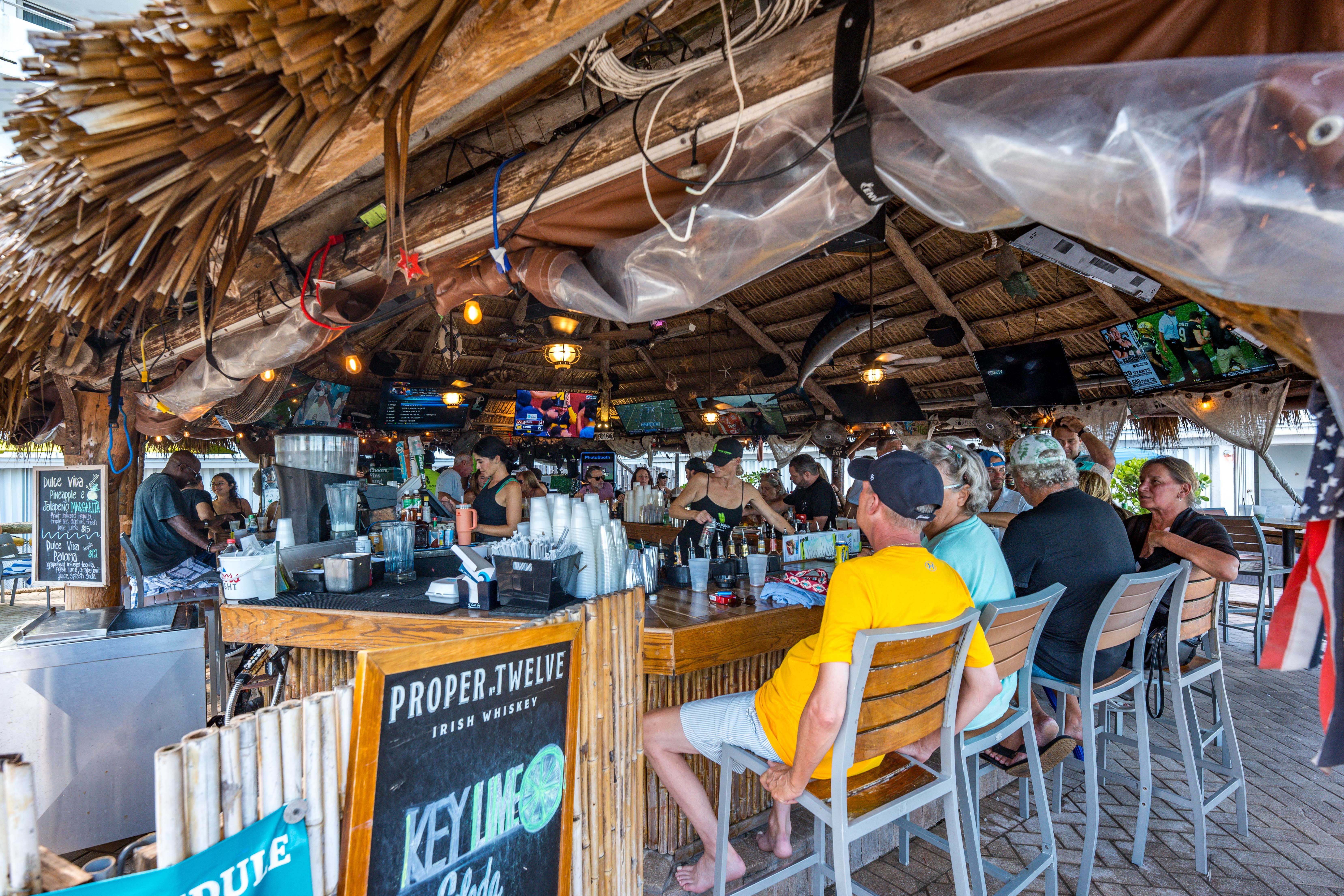 Sports bar area with TVs at Bamboo Beach Tiki Bar