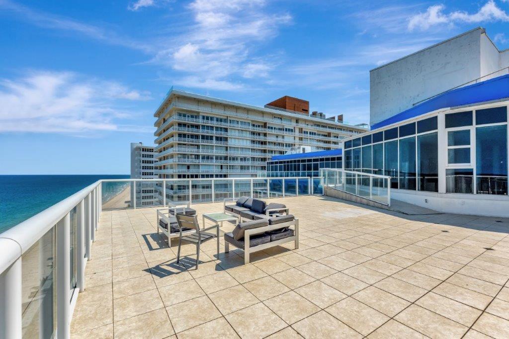 Private rooftop terrace with lounge seating and ocean views